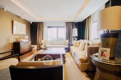 Luxurious living room with elegant decor and large windows offering natural light.