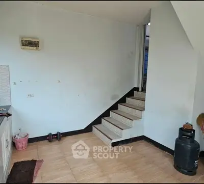 Spacious interior with staircase and kitchen area, ideal for customization.