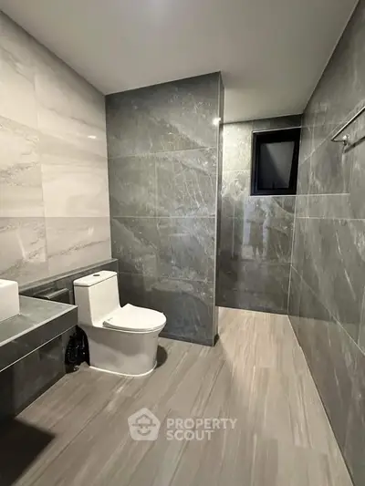 Modern bathroom with sleek gray tiles and spacious layout