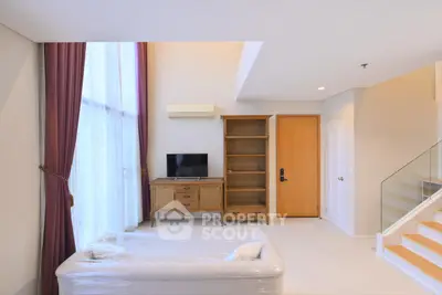 Spacious living room with high ceilings and elegant decor in modern apartment