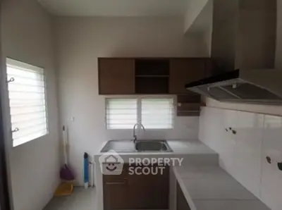 Compact kitchen with modern cabinetry and stainless steel sink