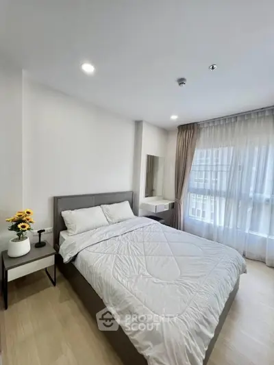 Modern bedroom with large window and stylish decor in a bright apartment