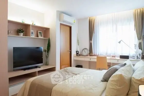 Modern bedroom with stylish decor and natural light