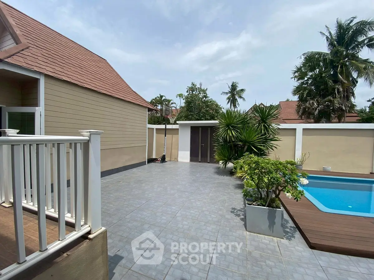 Charming backyard with pool and lush greenery, perfect for relaxation and entertainment.