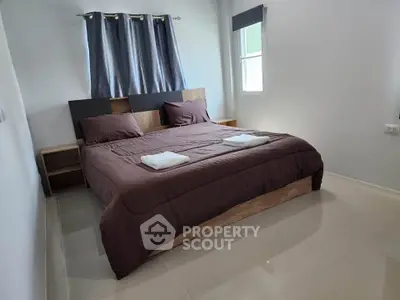 Spacious bedroom with modern decor and natural light