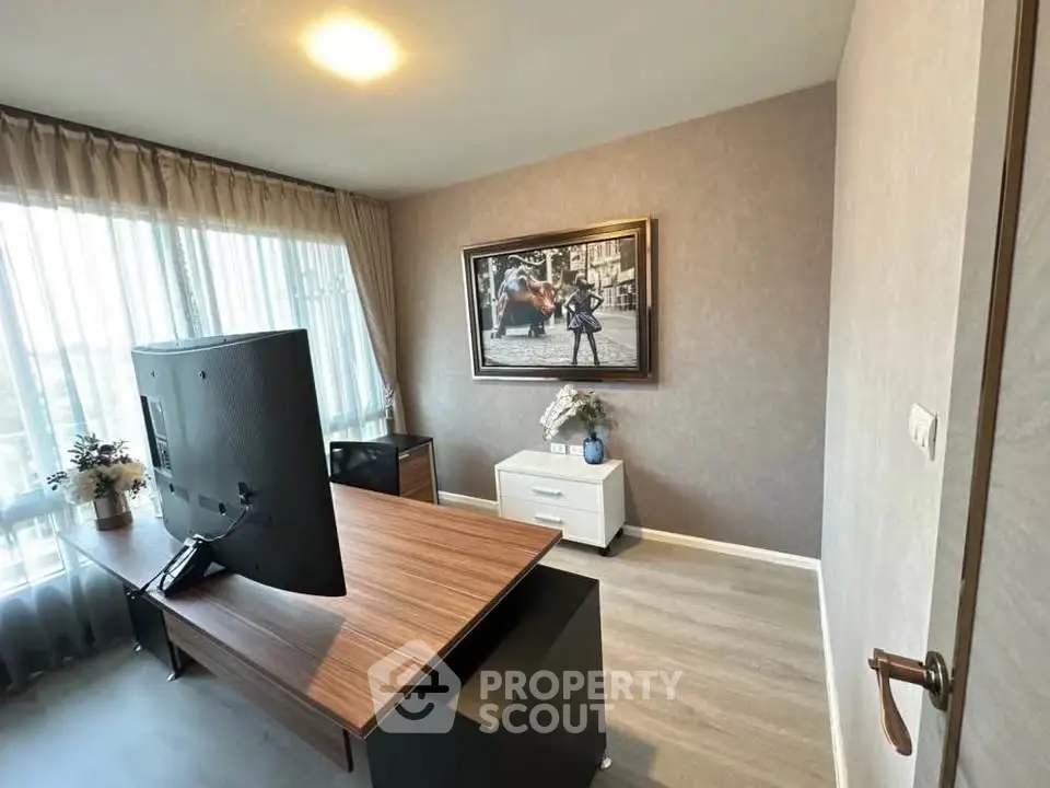 Modern study room with large desk and stylish decor in a bright apartment.