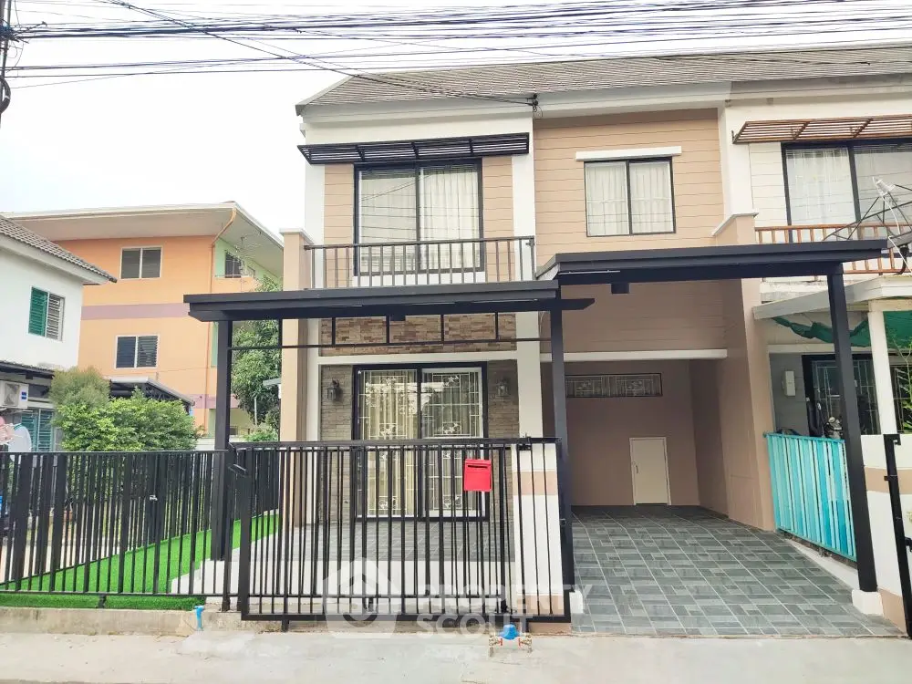 Modern two-story house with gated driveway and stylish facade