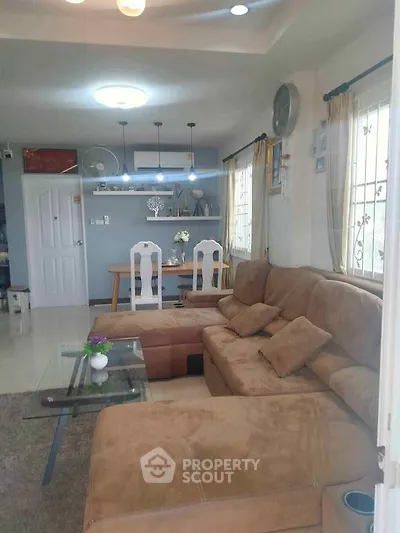 Spacious living room with cozy sectional sofa and modern decor, perfect for relaxation and entertaining.