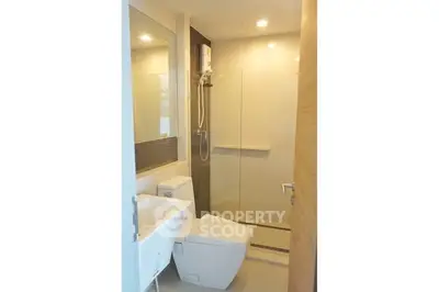 Modern bathroom with sleek fixtures and glass shower enclosure