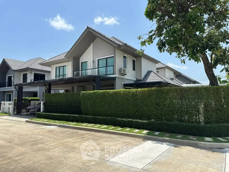 Modern two-story house with lush greenery and spacious driveway in a serene neighborhood.