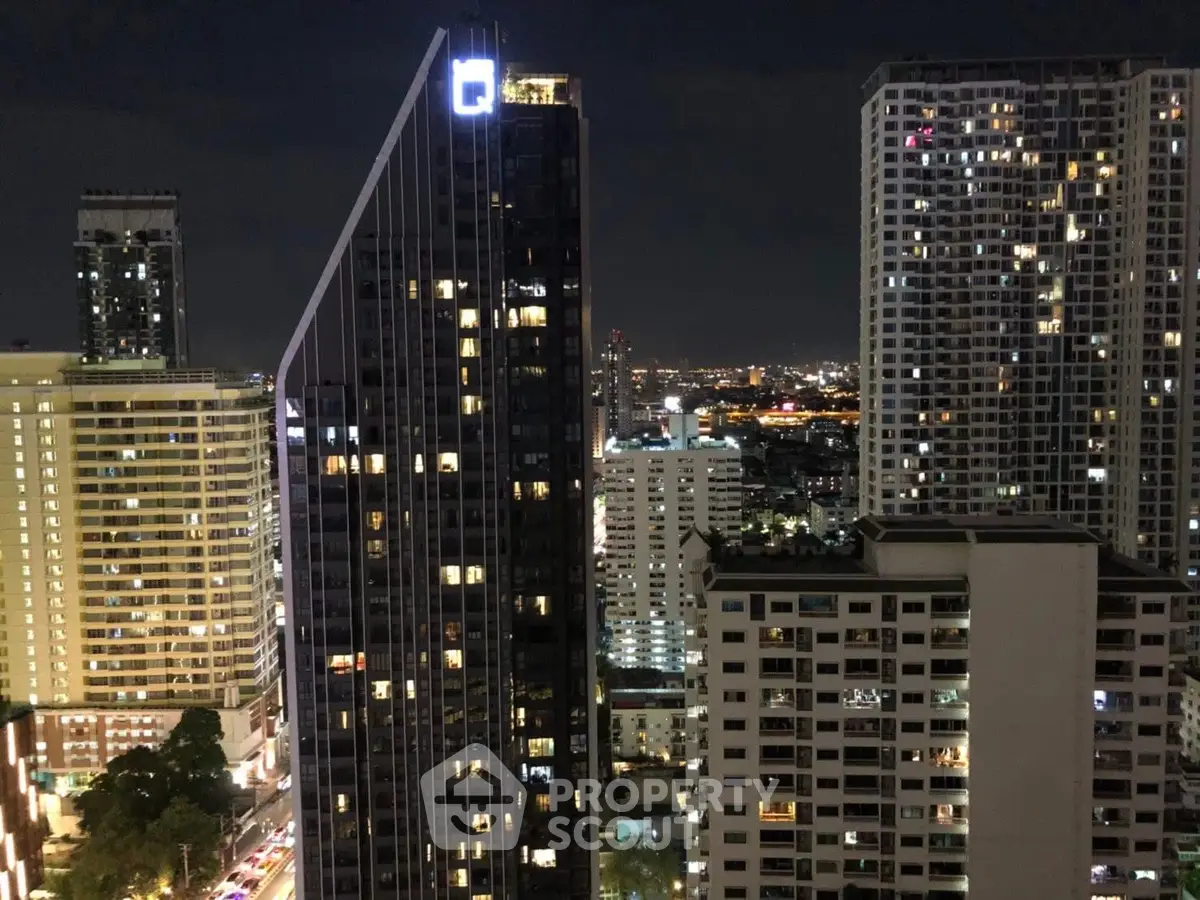 Stunning cityscape view of illuminated high-rise buildings at night, showcasing urban living.