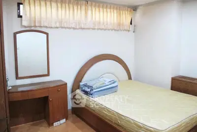 Cozy bedroom with wooden furniture and natural light