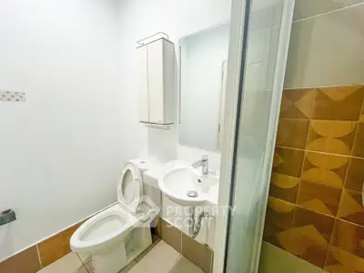 Modern bathroom with sleek fixtures and a glass shower enclosure, perfect for contemporary living.