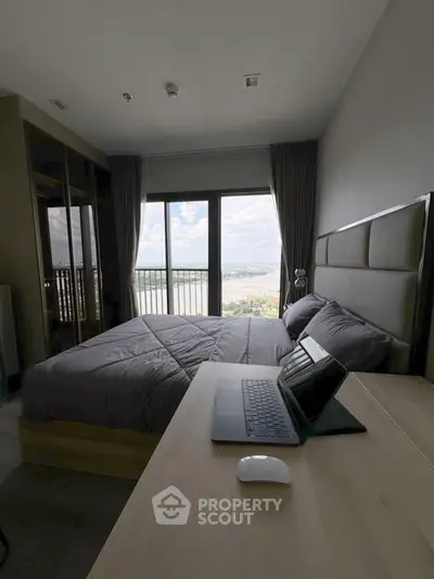 Modern bedroom with stunning river view and sleek workspace