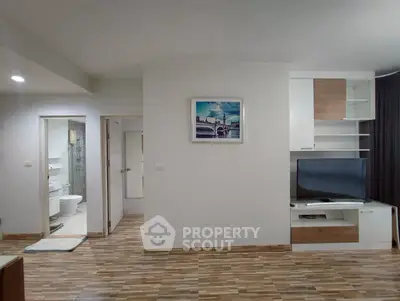 Modern living room with stylish wooden flooring and built-in TV unit