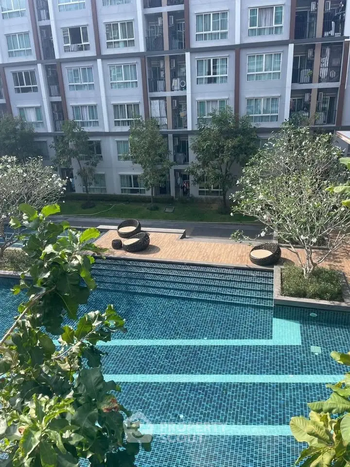 Luxurious apartment complex with stunning pool and lush greenery