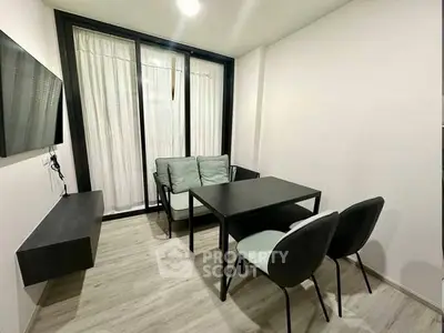 Modern minimalist living room with sleek furniture and large window for natural light.