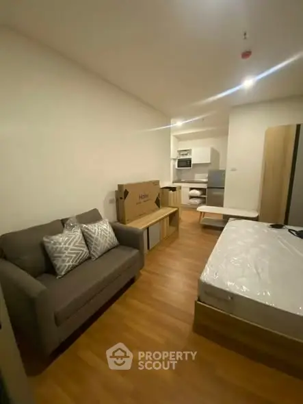 Modern studio apartment with cozy living area and compact kitchen