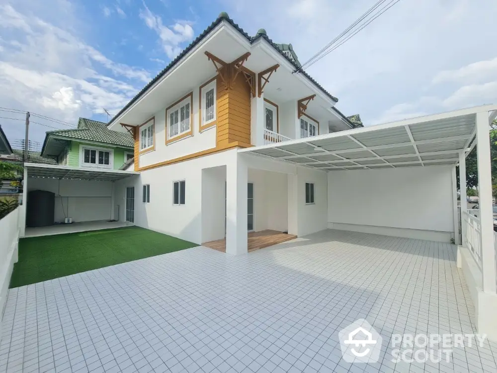 Spacious modern house with tiled driveway and green lawn, perfect for family living.