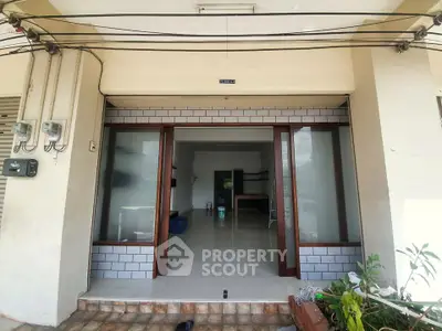 Spacious commercial property entrance with large glass doors and tiled flooring, ideal for business setup.