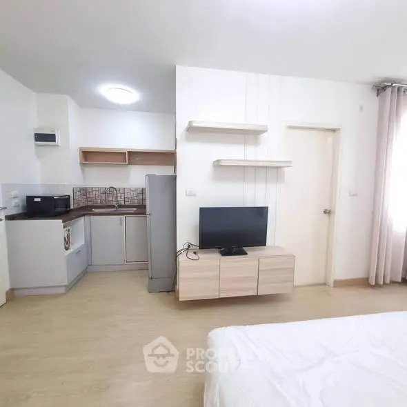 Modern studio apartment with open kitchen and cozy living area