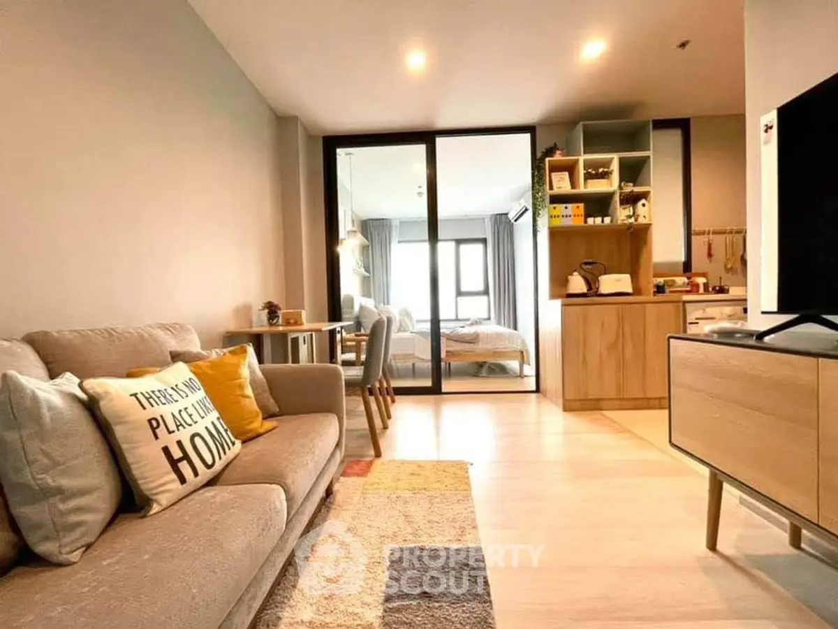 Modern living room with cozy sofa and open view to bedroom, stylish decor