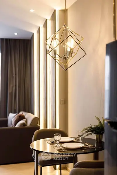 Modern dining area with stylish lighting and cozy seating in a contemporary apartment.