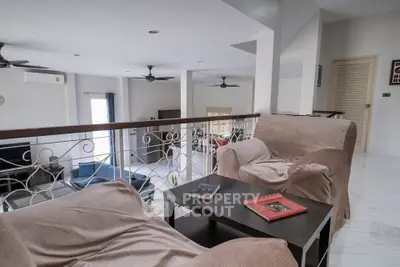 Spacious living room with modern decor and cozy seating area, perfect for relaxation and entertainment.