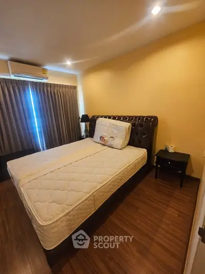 Cozy bedroom with elegant bed and warm lighting, perfect for relaxation.