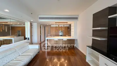 Modern open-plan living room with sleek kitchen and wooden flooring