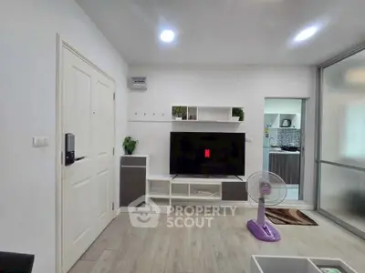 Modern living room with sleek TV unit and stylish decor in a contemporary apartment.