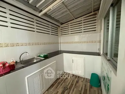 Charming small kitchen with modern design and ample storage space, perfect for cozy cooking experiences.