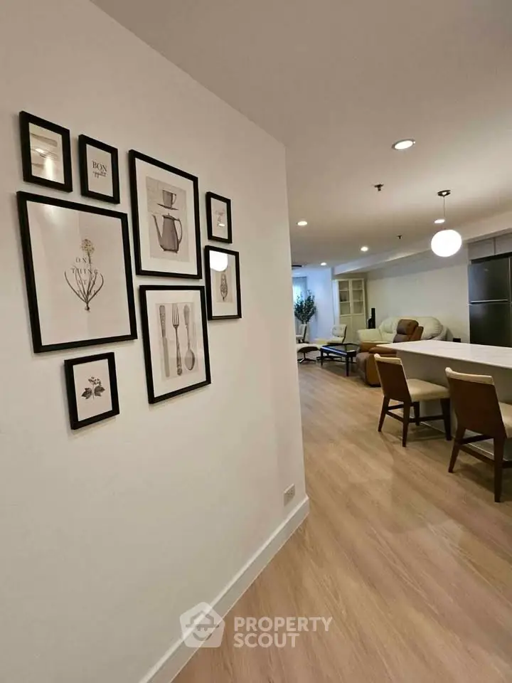Stylish open-plan living room with modern decor and elegant wall art, perfect for contemporary living.