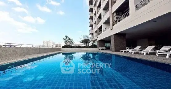 Luxurious apartment building with stunning rooftop pool and city views.