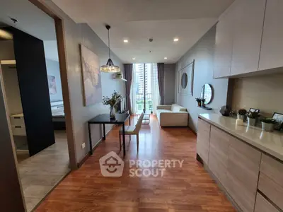 Modern open-plan living room with wooden flooring and city view balcony.
