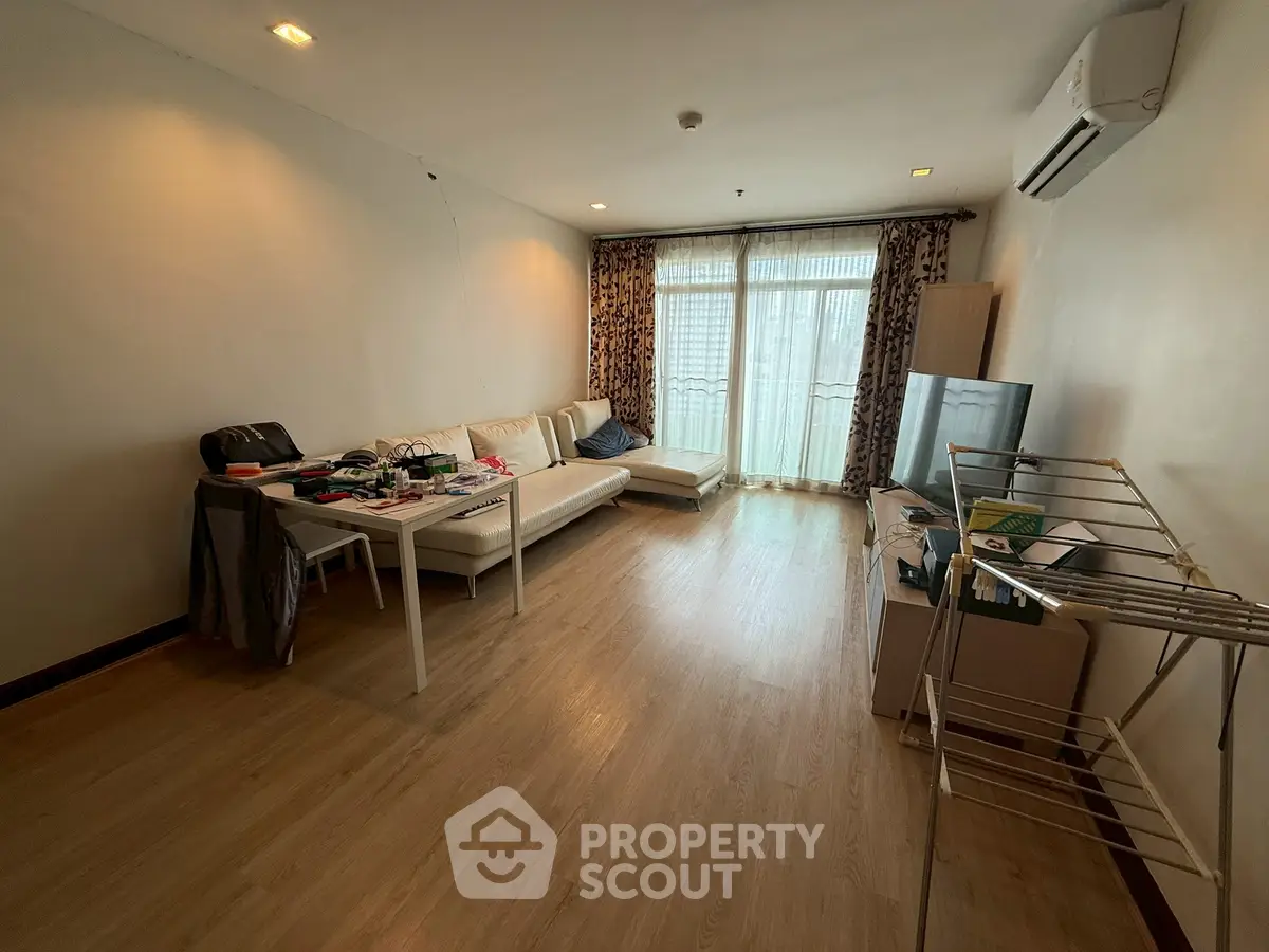 Spacious living room with modern furniture and large windows for natural light.