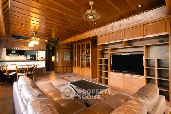 Spacious living room with wooden interiors and modern furnishings in a luxury home.
