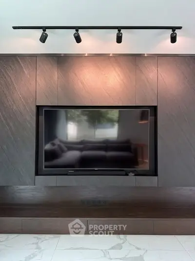 Modern living room with sleek built-in TV and stylish lighting