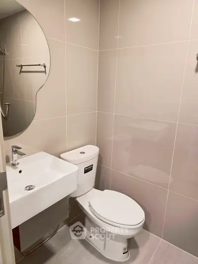 Modern bathroom with sleek fixtures and elegant tile design, perfect for a contemporary home.