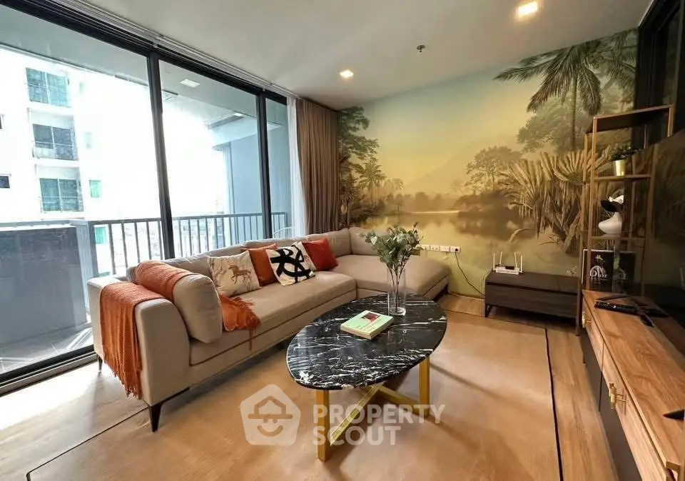 Stylish living room with modern decor and large windows overlooking balcony.