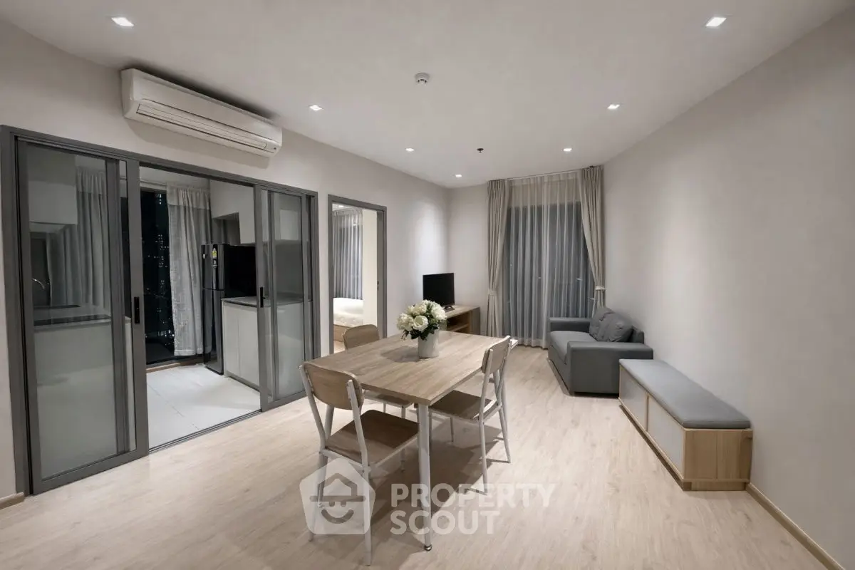 Modern living room with sleek furniture and open balcony view
