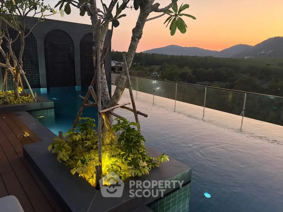 Stunning rooftop infinity pool with panoramic mountain views at sunset, perfect for luxury living.