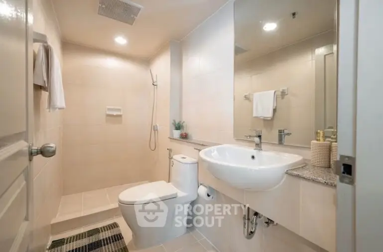 Modern bathroom with sleek fixtures and spacious shower area