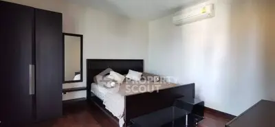 Modern bedroom with sleek furniture and air conditioning, perfect for comfort and style.