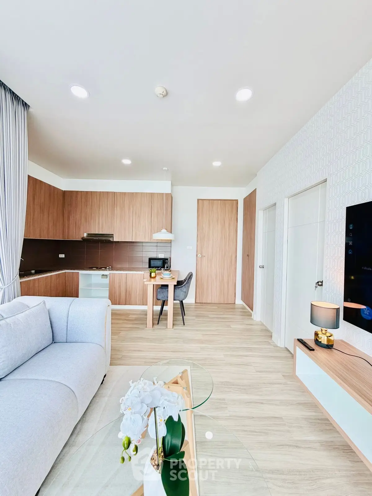 Modern open-plan living room with stylish kitchen and cozy dining area