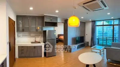 Modern open-plan living room with kitchen and balcony view