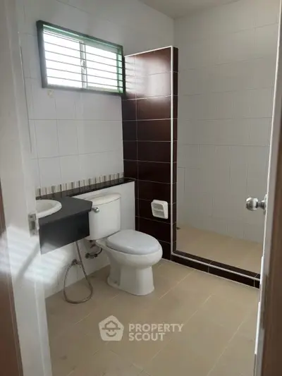 Modern bathroom with sleek design and tiled shower area.