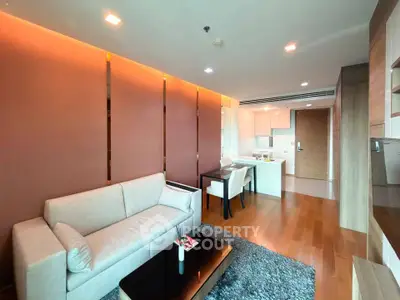 Modern living room with elegant decor and open kitchen layout in a stylish apartment.