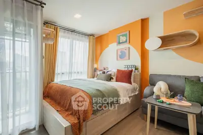 Cozy bedroom with modern decor, vibrant orange accents, and large windows for natural light.