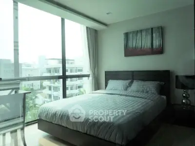 Modern bedroom with large window and stylish decor in urban apartment